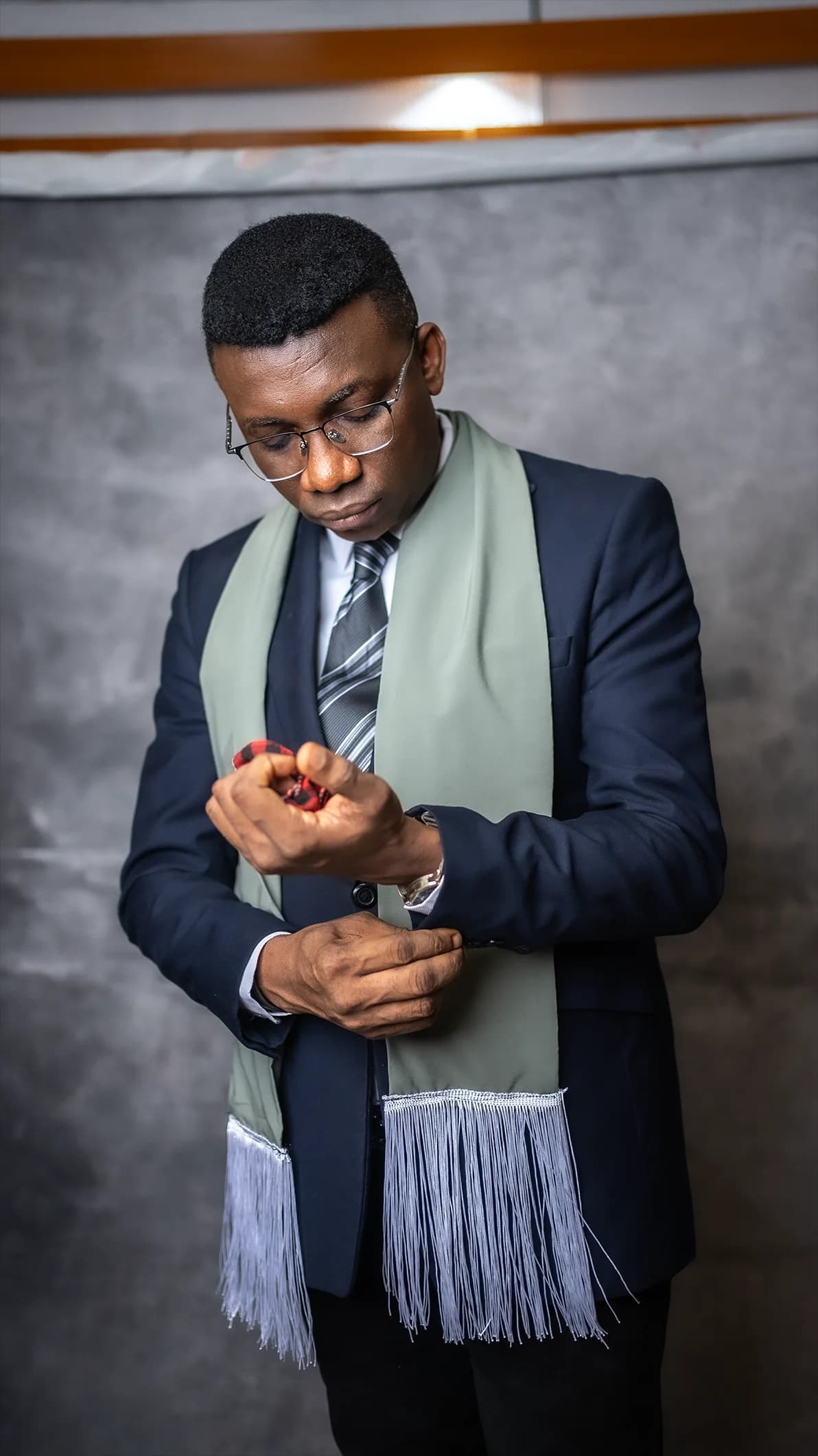 Johnson Abbaly in a quiet moment, adjusting his suit